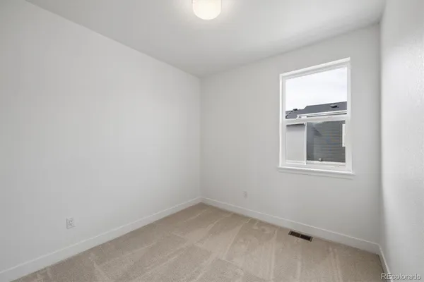 a view of an empty room and a window