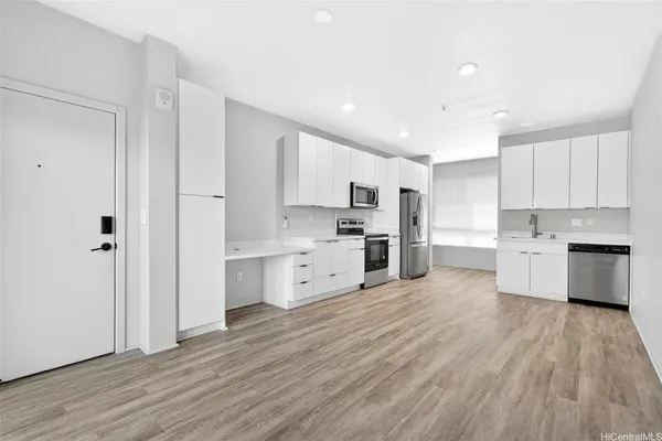 a kitchen with stainless steel appliances a refrigerator sink and cabinets