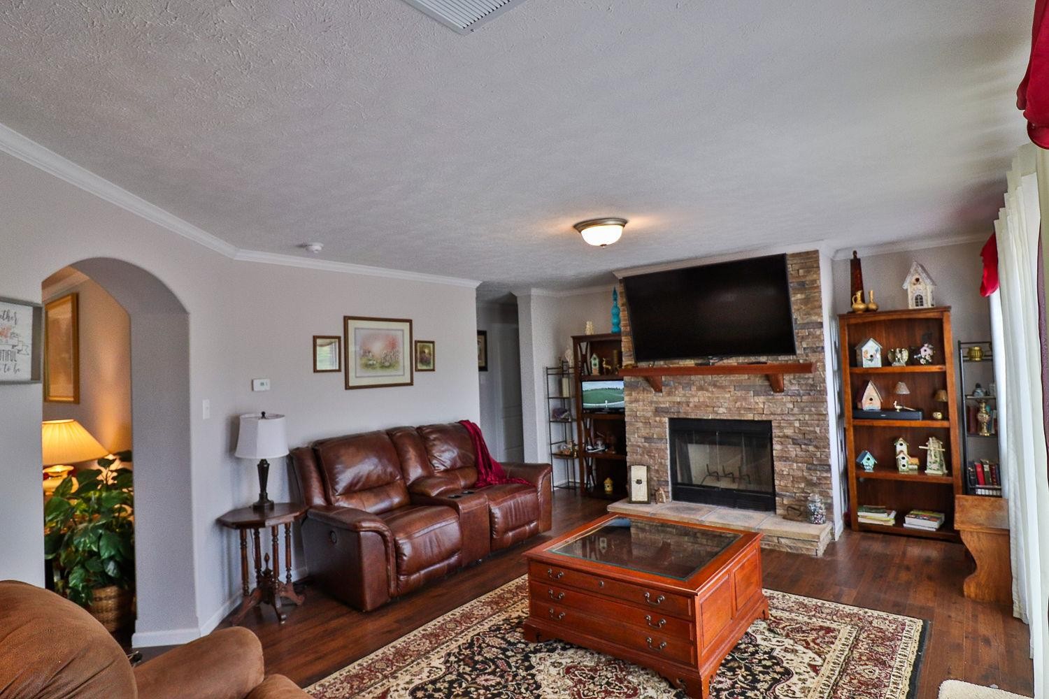 492 Cook Road Portland, TN 37148 - Photo 19 of 28 a living room with furniture a flat screen tv and a fireplace