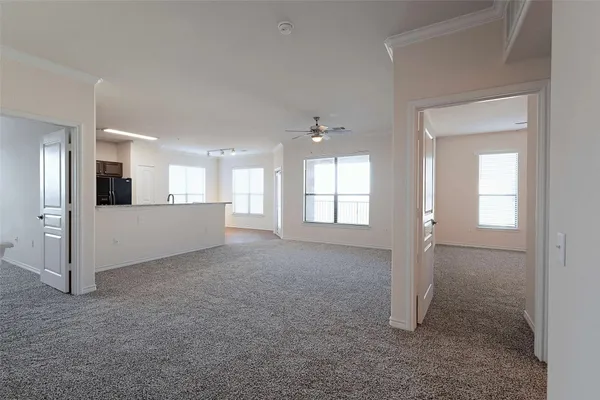a view of a big room with closet and windows