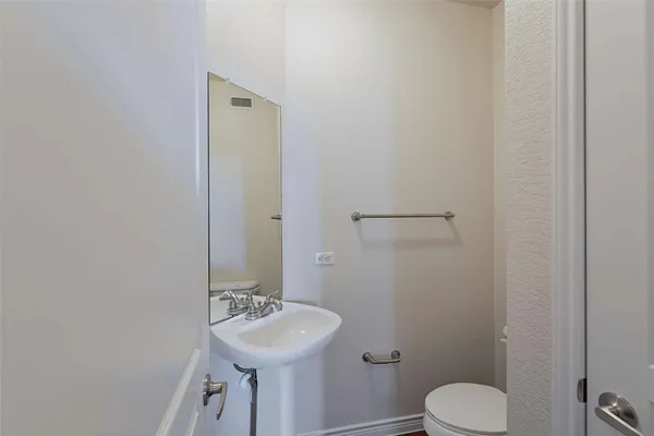 a bathroom with a sink toilet and mirror