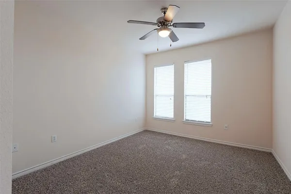 an empty room with a empty space and a ceiling fan