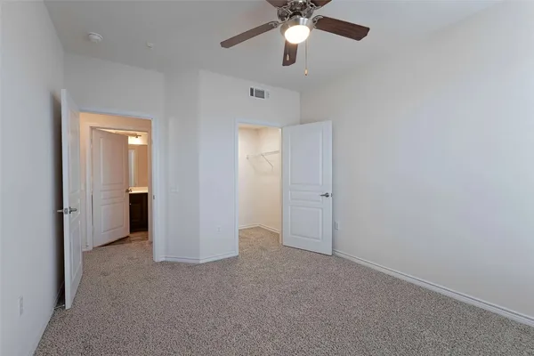 an empty room with a empty space and a ceiling fan
