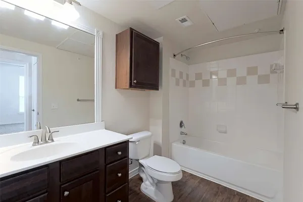 a bathroom with a sink toilet a mirror and shower
