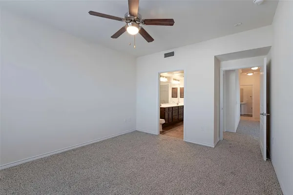 an empty room and chandelier fan in a room