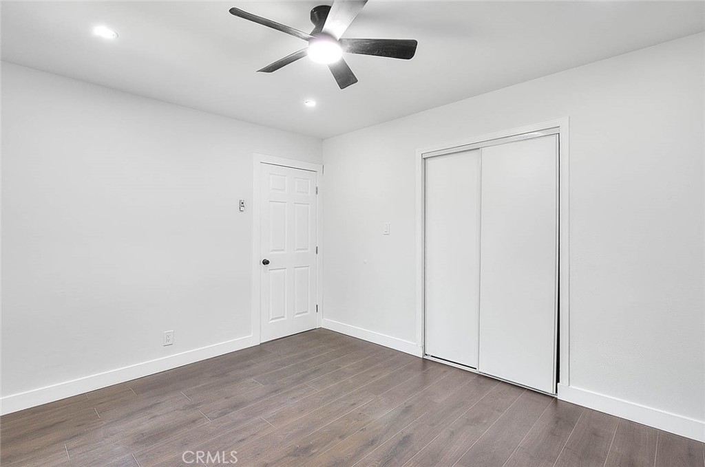 2112 California Duarte, CA 91010 - Photo 41 of 71 an empty room with wooden floor a ceiling fan & windows