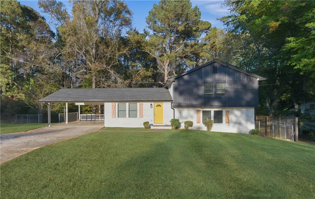 a house that has a tree in front of it