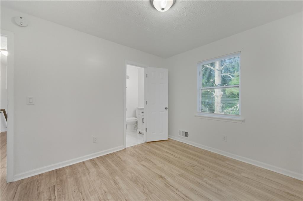 4974 Browns Mill Road Lithonia, GA 30038 - Photo 11 of 18 an empty room with a window