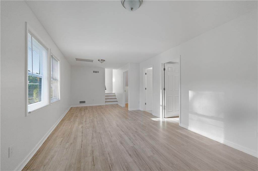 4974 Browns Mill Road Lithonia, GA 30038 - Photo 14 of 18 a view of an empty room with wooden floor and window