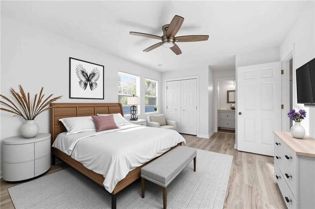 4974 Browns Mill Road Lithonia, GA 30038 - Photo 5 of 18 a spacious bedroom with a bed and a chandelier