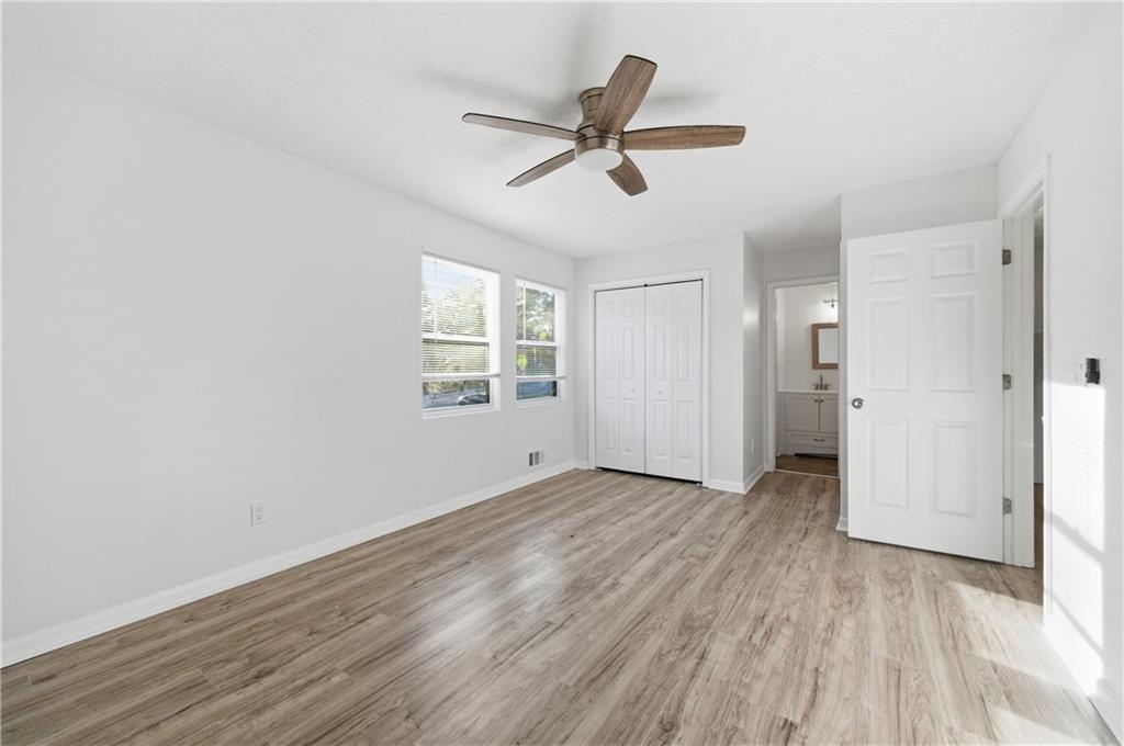 4974 Browns Mill Road Lithonia, GA 30038 - Photo 6 of 18 a view of an empty room with wooden floor and a window