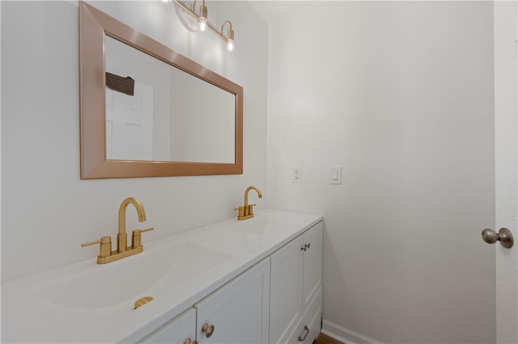 4974 Browns Mill Road Lithonia, GA 30038 - Photo 8 of 18 a bathroom with a sink and a mirror