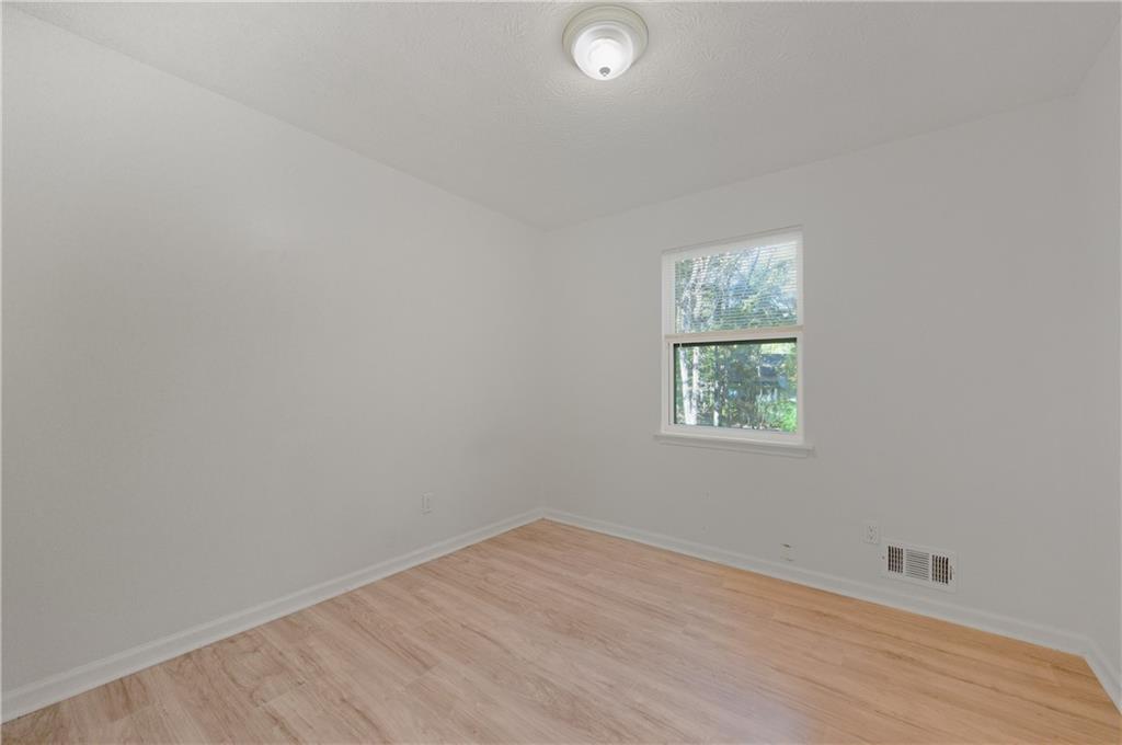 4974 Browns Mill Road Lithonia, GA 30038 - Photo 9 of 18 an empty room with a window