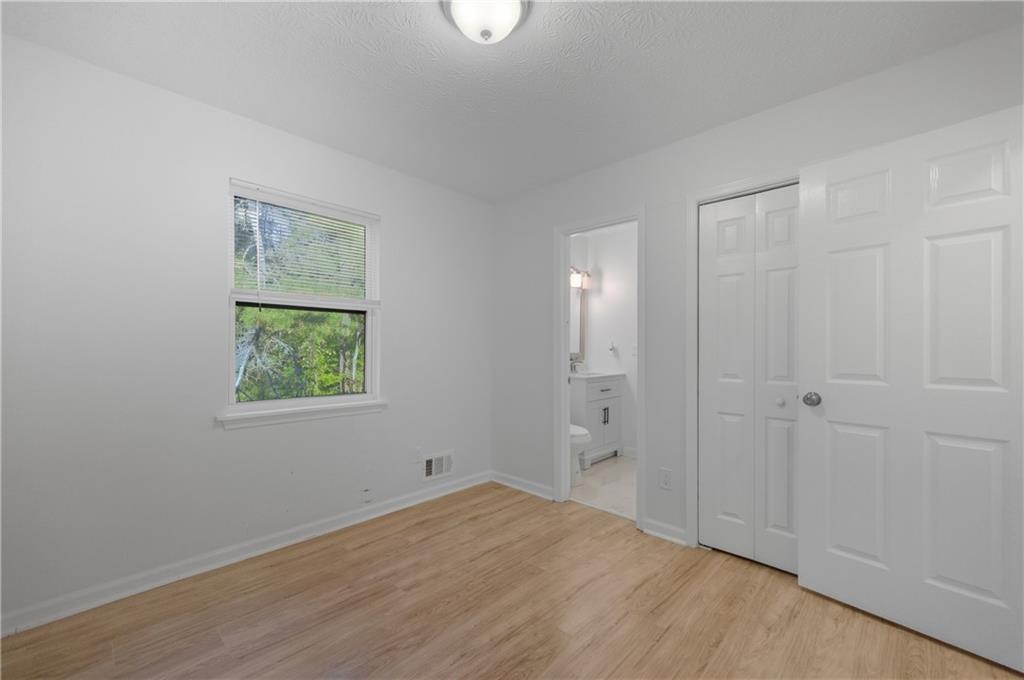 4974 Browns Mill Road Lithonia, GA 30038 - Photo 10 of 18 a view of an empty room with window and closet area