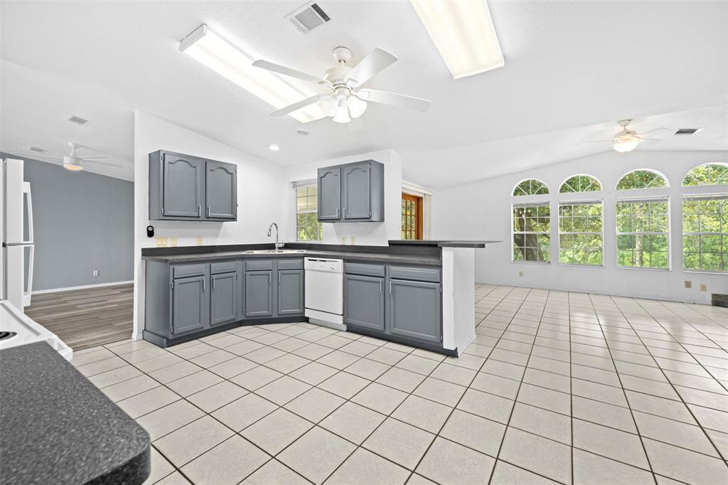 33320 Larkin Road Dade City, FL 33523 - Photo 18 of 60 a kitchen with stainless steel appliances a sink and a stove top oven