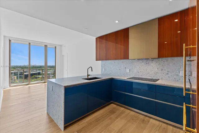 a kitchen with sink and cabinets