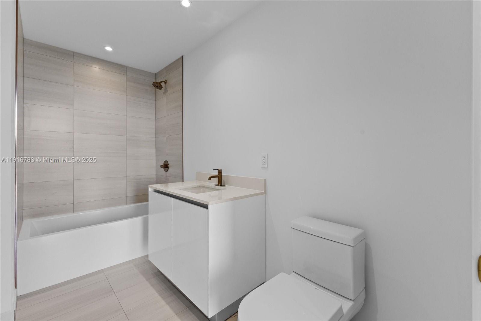 2678 Tigertail Avenue, Unit 1605 Miami, FL 33133 - Photo 12 of 17 a bathroom with a sink toilet and shower