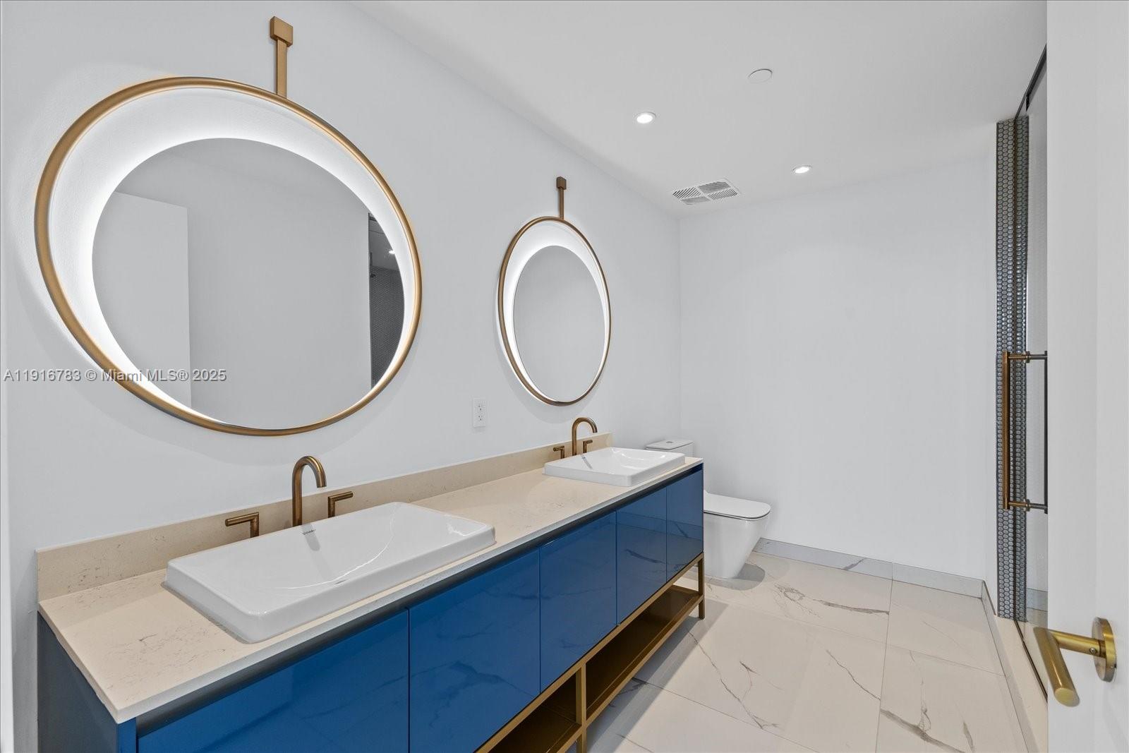 2678 Tigertail Avenue, Unit 1605 Miami, FL 33133 - Photo 9 of 17 a bathroom with a sink and a mirror