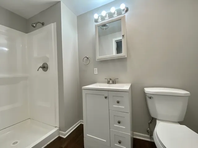 a bathroom with a toilet sink and shower