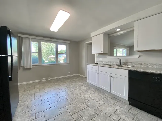 a large bathroom with a granite countertop sink and a window