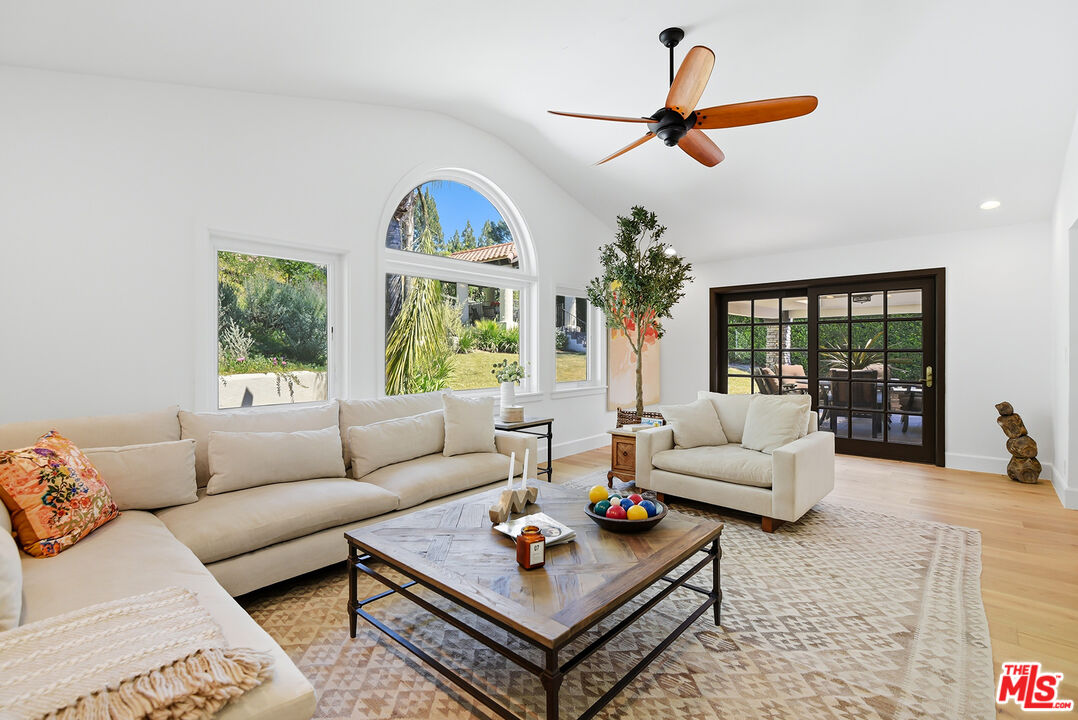 a living room with furniture a couch and a chandelier