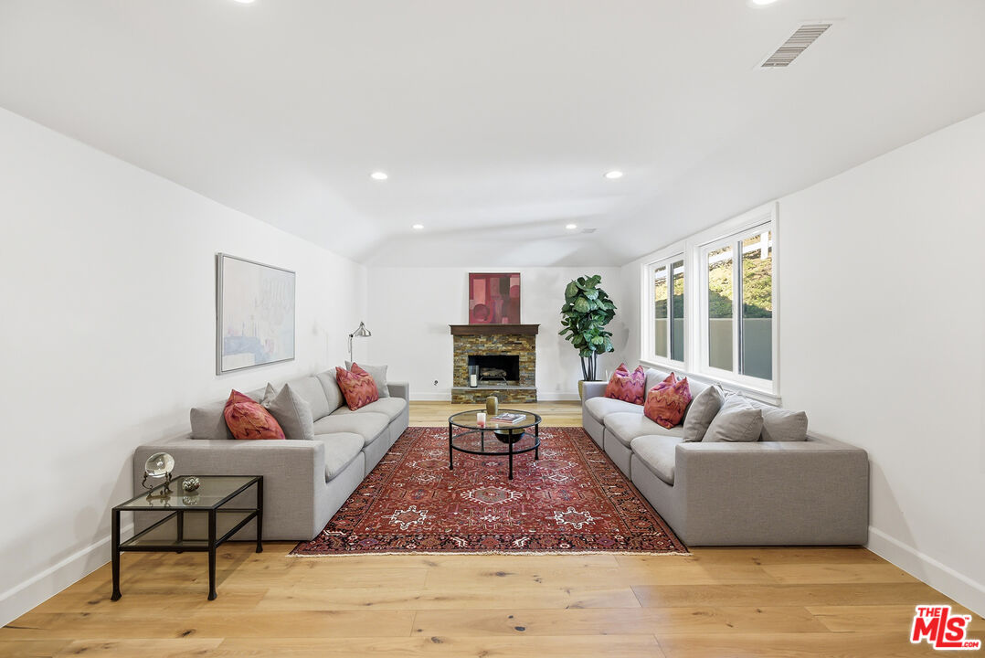 10 Baymare Road Bell Canyon, CA 91307 - Photo 16 of 54 a living room with fireplace furniture and a wooden floor