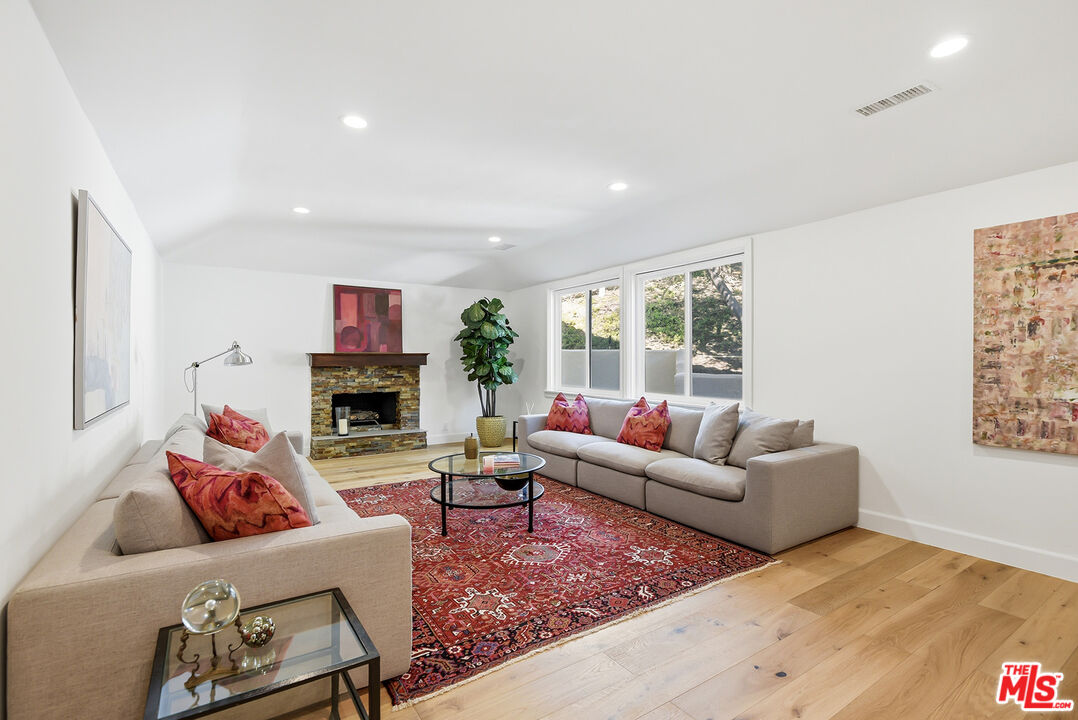 10 Baymare Road Bell Canyon, CA 91307 - Photo 17 of 54 a living room with furniture a fireplace and a floor to ceiling window