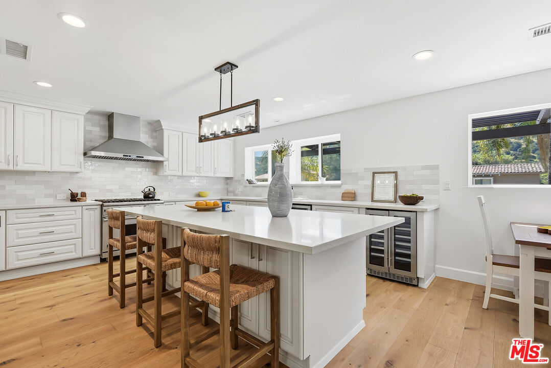 10 Baymare Road Bell Canyon, CA 91307 - Photo 9 of 54 a kitchen with a table chairs sink and cabinets
