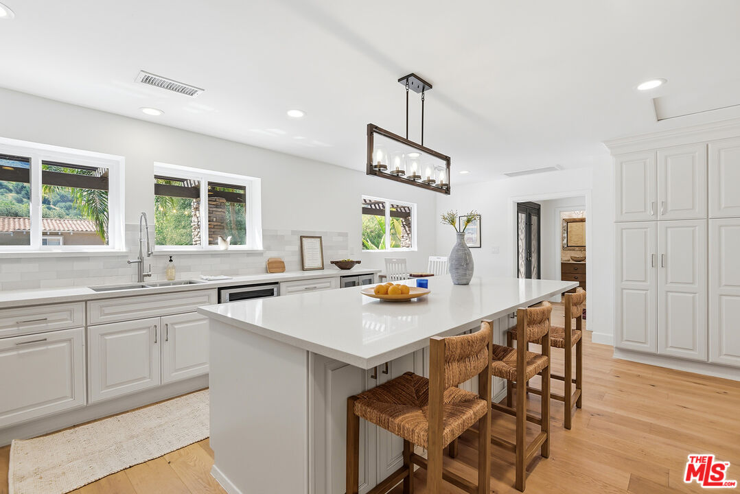 10 Baymare Road Bell Canyon, CA 91307 - Photo 10 of 54 a kitchen with stainless steel appliances a sink a stove a table and chairs