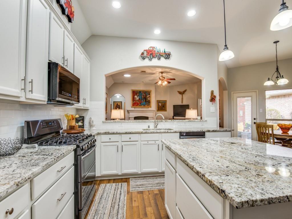 9962 Bell Rock Road Frisco, TX 75035 - Photo 6 of 28 a large kitchen with granite countertop a sink and cabinets