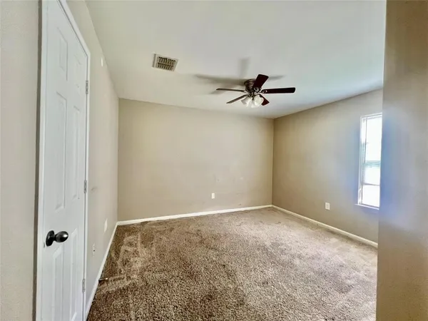 a view of a livingroom with a ceiling fan and window