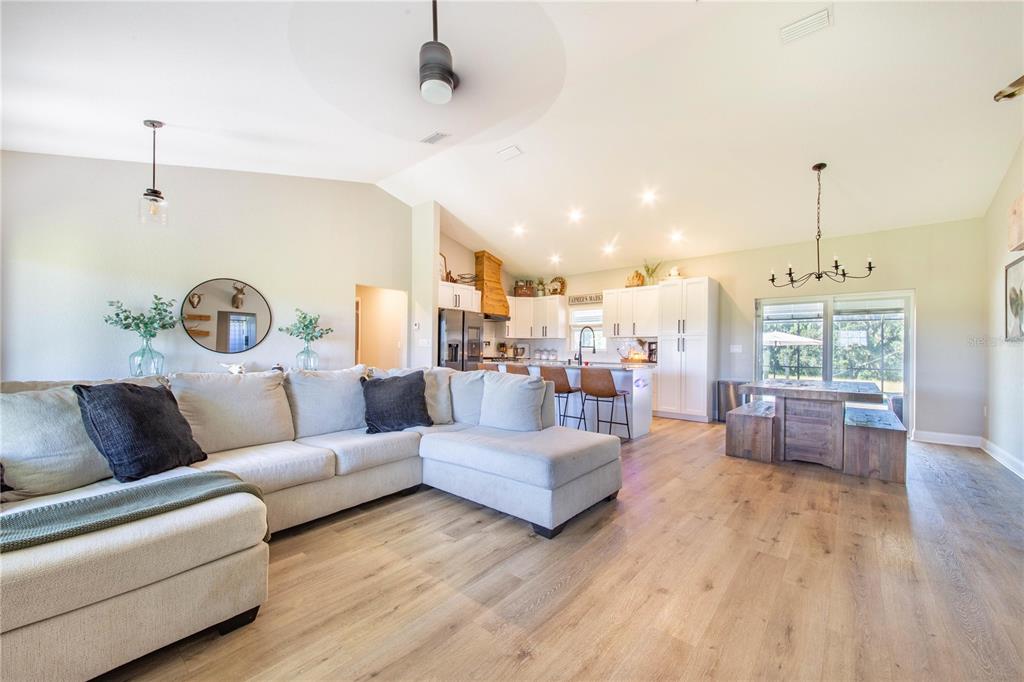 705 Brook Road North Fort Meade, FL 33841 - Photo 11 of 54 a living room with furniture or couch and a chandelier