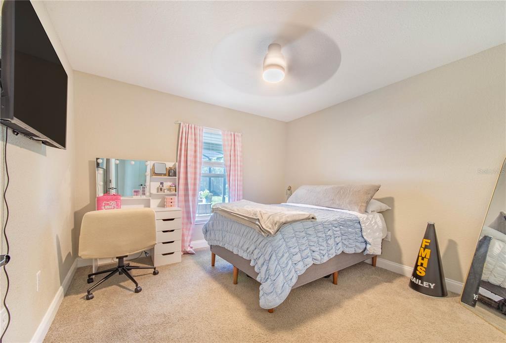 705 Brook Road North Fort Meade, FL 33841 - Photo 12 of 54 a bedroom with furniture and a flat screen tv