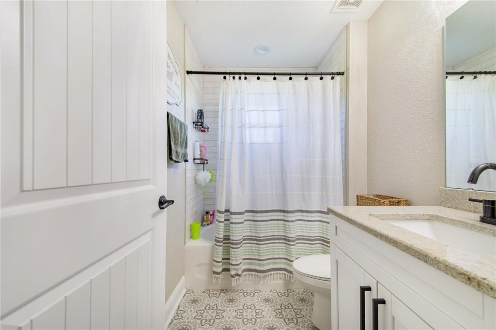 705 Brook Road North Fort Meade, FL 33841 - Photo 13 of 54 a bathroom with a granite countertop sink and a mirror