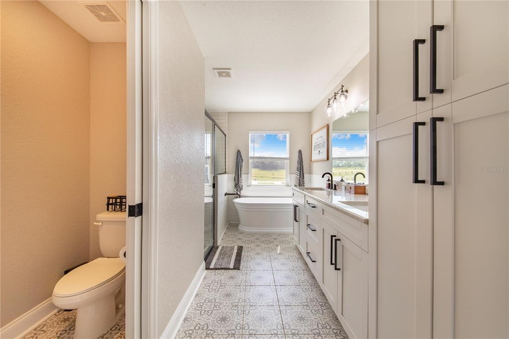 705 Brook Road North Fort Meade, FL 33841 - Photo 19 of 54 a large white bathroom with a granite countertop sink a toilet a shower and a mirror