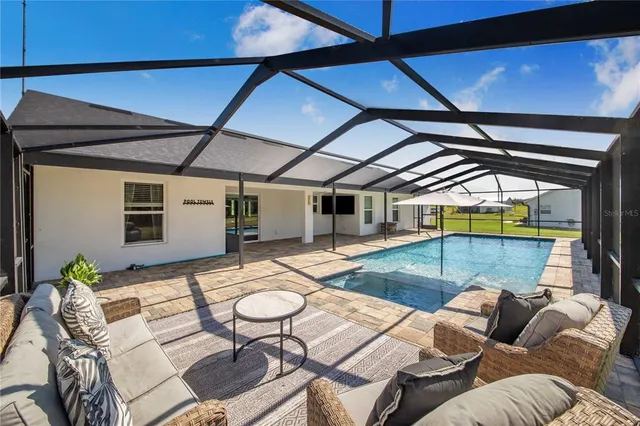 a view of a swimming pool with a yard