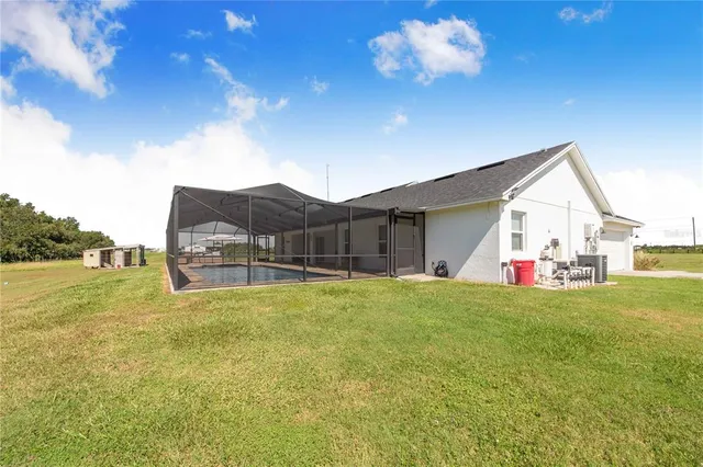 a view of a house with a yard and swimming pool