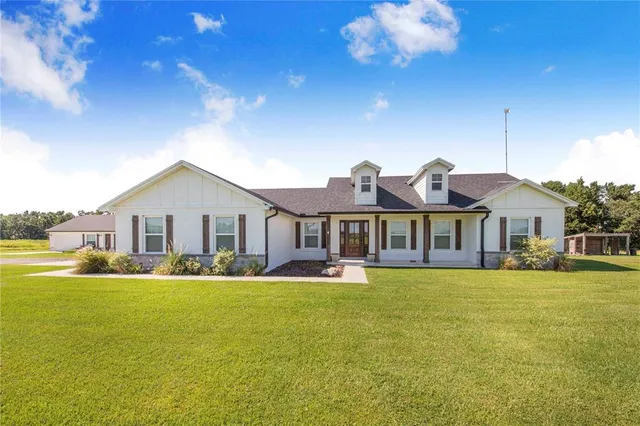a front view of a house with a yard table and chairs