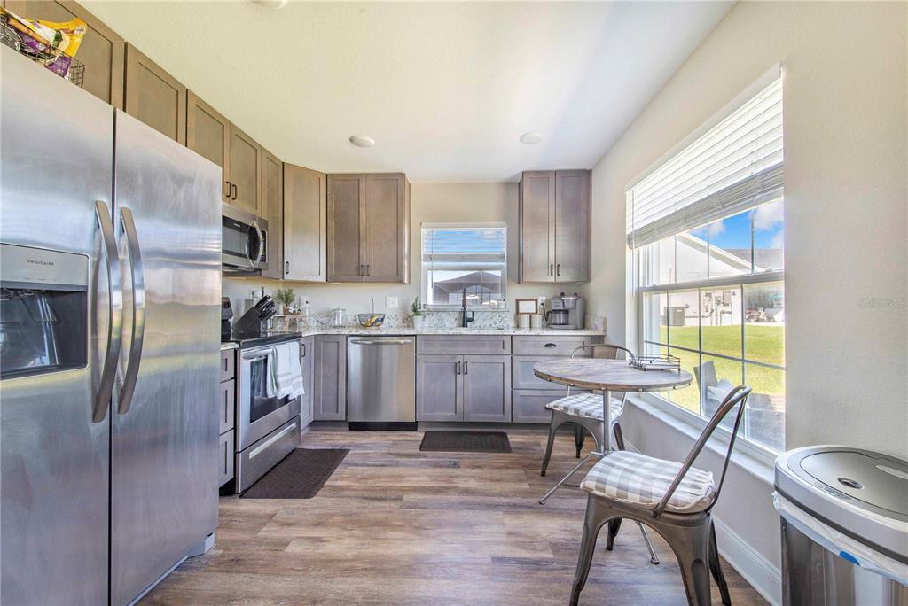 705 Brook Road North Fort Meade, FL 33841 - Photo 37 of 54 a kitchen with kitchen island white cabinets and stainless steel appliances