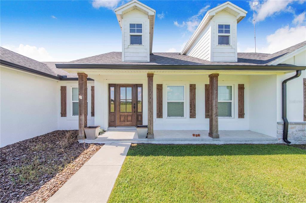 705 Brook Road North Fort Meade, FL 33841 - Photo 4 of 54 a front view of a house with a yard table and chairs