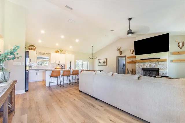 a kitchen with stainless steel appliances granite countertop a dining table chairs and granite counter tops