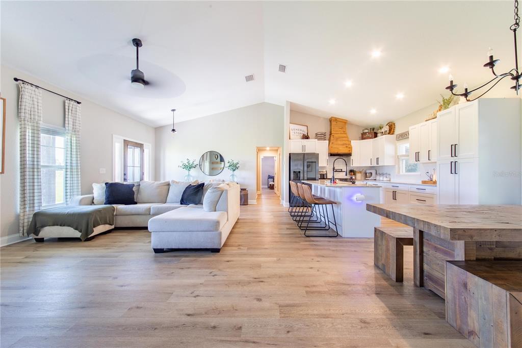 705 Brook Road North Fort Meade, FL 33841 - Photo 8 of 54 a living room with furniture and a chandelier