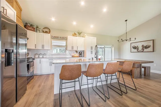 a living room with furniture or couch and a chandelier