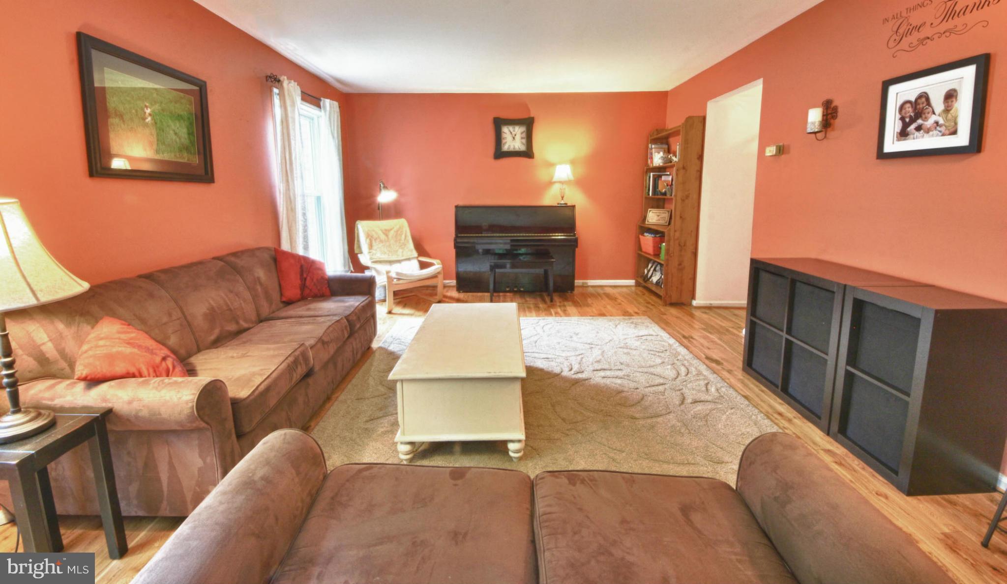 6285 Rathlin Drive Springfield, VA 22152 - Photo 2 of 18 a living room with furniture and a flat screen tv