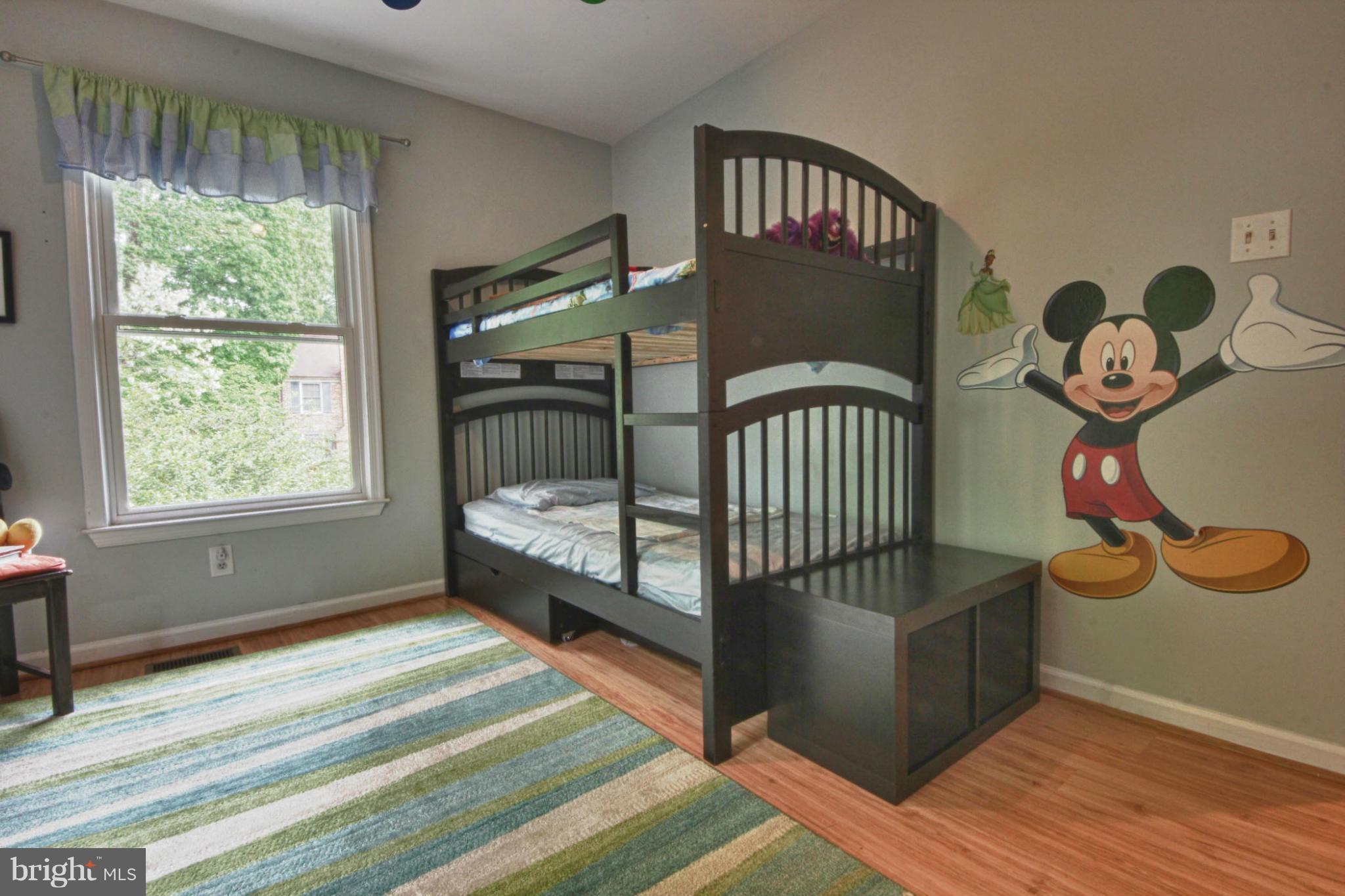 6285 Rathlin Drive Springfield, VA 22152 - Photo 11 of 18 a bedroom with a bed and wooden floor