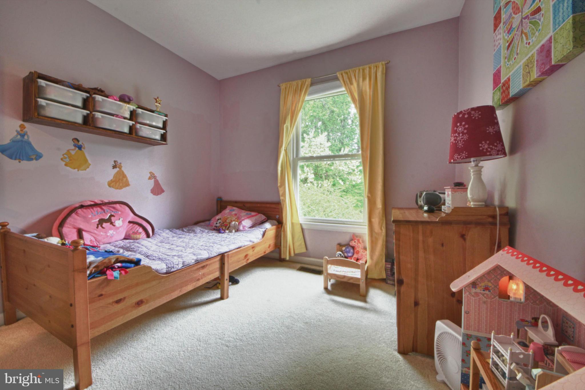 6285 Rathlin Drive Springfield, VA 22152 - Photo 12 of 18 a bedroom with a bed and a window