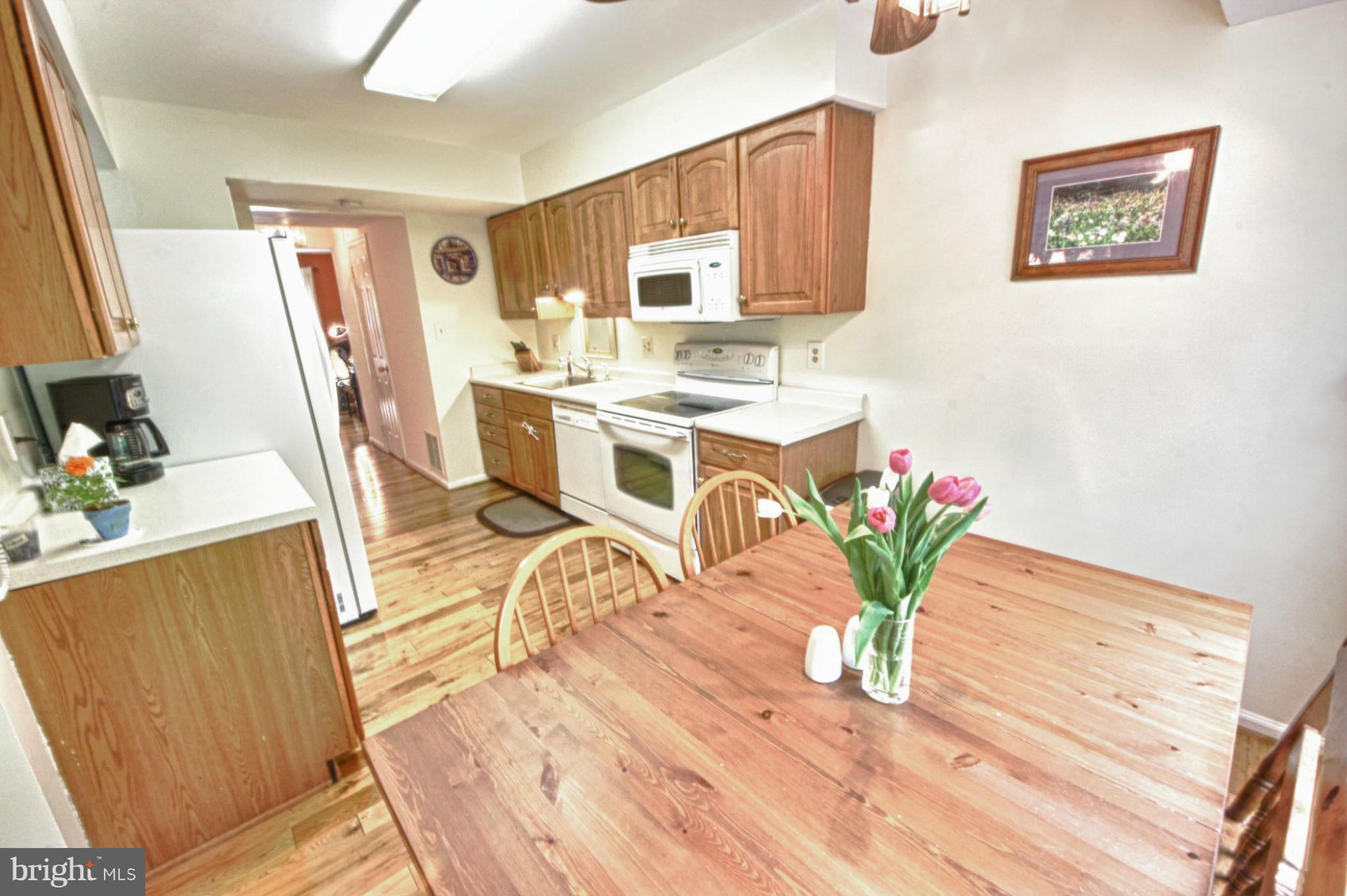 6285 Rathlin Drive Springfield, VA 22152 - Photo 5 of 18 a living room with furniture a wooden floor and a sink