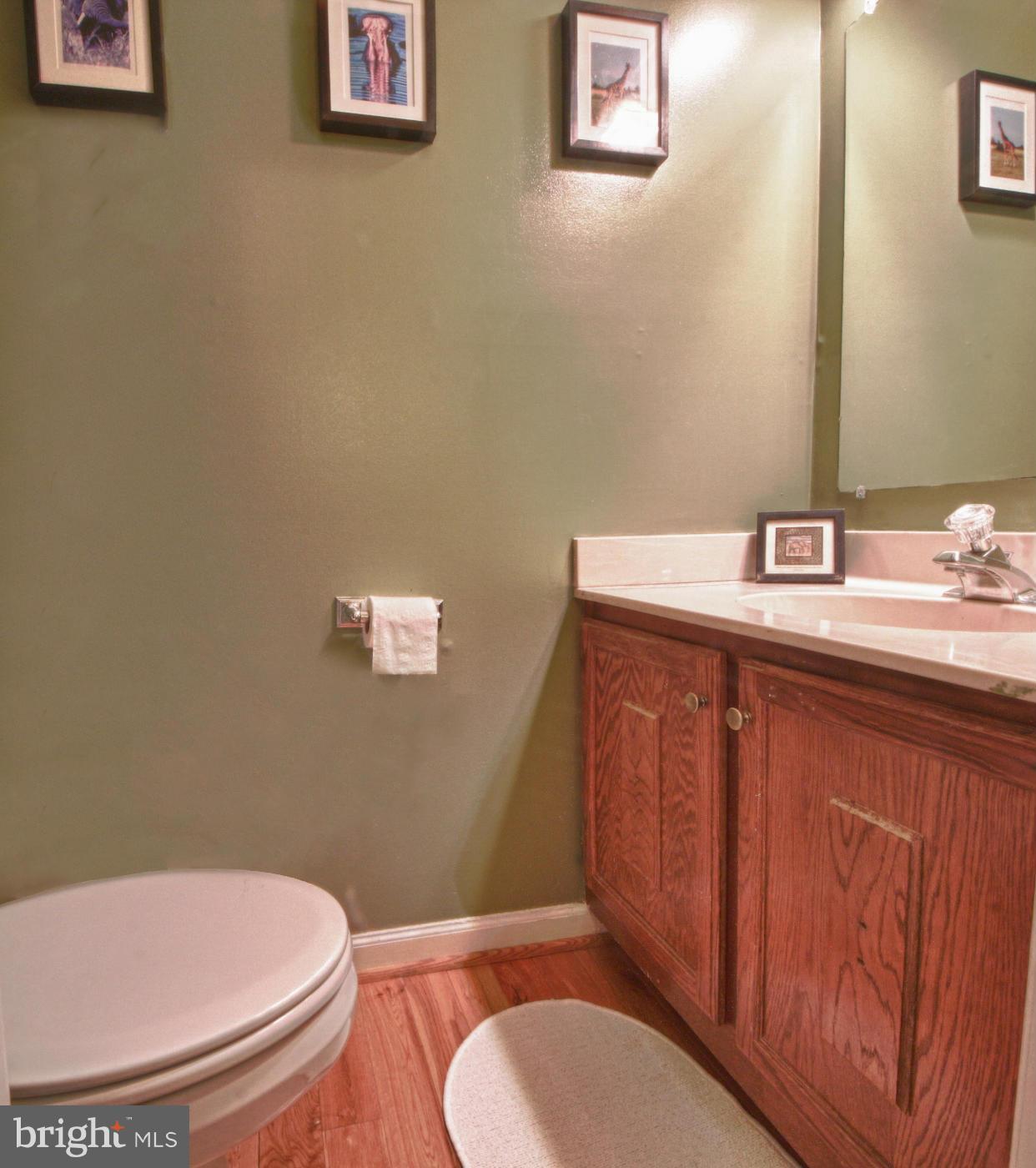 6285 Rathlin Drive Springfield, VA 22152 - Photo 8 of 18 a bathroom with a granite countertop toilet sink and mirror