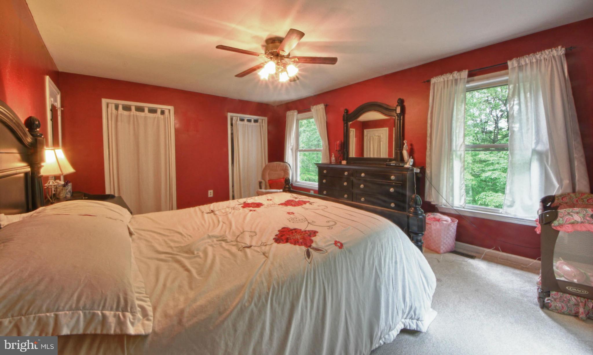 6285 Rathlin Drive Springfield, VA 22152 - Photo 9 of 18 a bedroom with a large bed and a window
