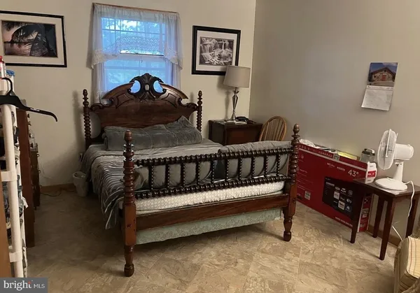a bed room with a bed and a chair
